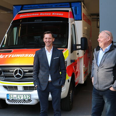 Bild vergr��ern: Landrat Andreas M�ller (l.) und Thomas Leyener, allgemeiner Vertreter des B�rgermeisters der Gemeinde Burbach, freuen sich mit und f�r die DRK-Mitarbeiterinnen und -Mitarbeiter �ber die verbesserten Arbeitsbedingungen.