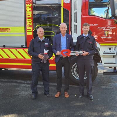 Bild vergr��ern: Thorsten Schneider, Leiter der Freiwilligen Feuerwehr Burbach, B�rgermeister Christoph Ewers und Einheitsf�hrer Ingo Petri (v.l.) bei der Schl�ssel�bergabe. Foto: Lutz Sch�fer